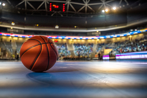 Close-up of basketball on court in stadium.