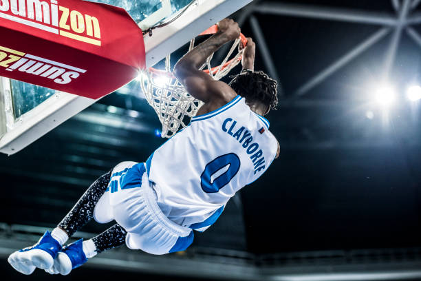 istock Basketball player hanging on hoop 1253346133