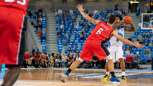 istock Basketball players tackling for ball 1253346976