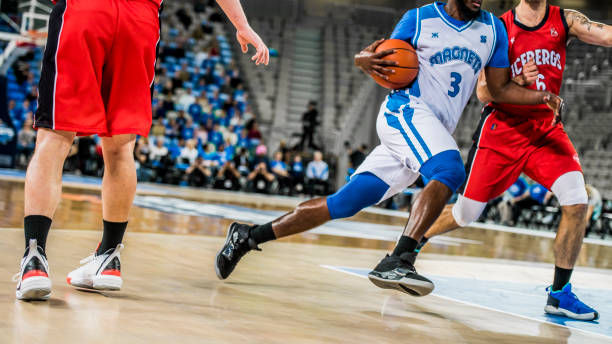 istock Basketball players tackling for ball 1253347081