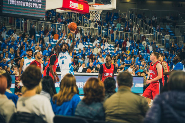 istock Basketball player aiming ball for hoop 1253347263