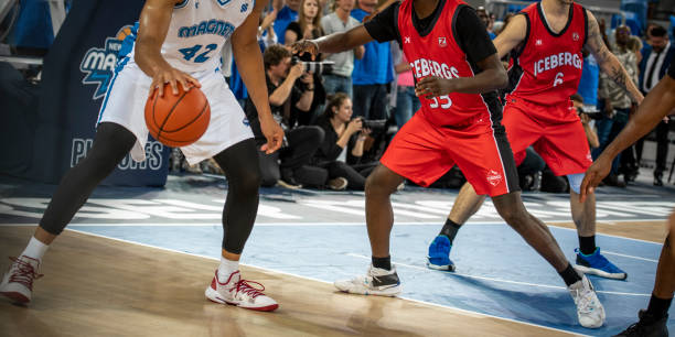istock Basketball players chasing for ball 1253347355