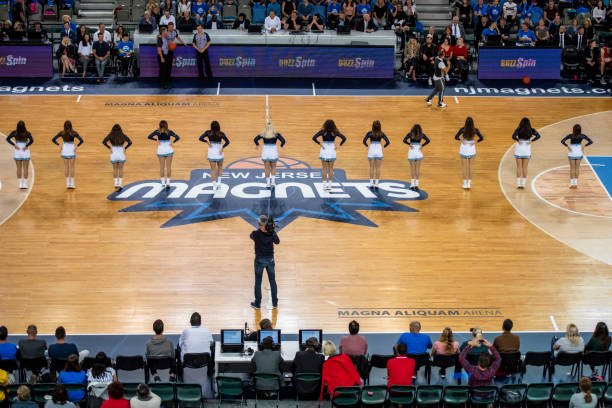 istock Cheerleaders performing on basketball court 1253348265