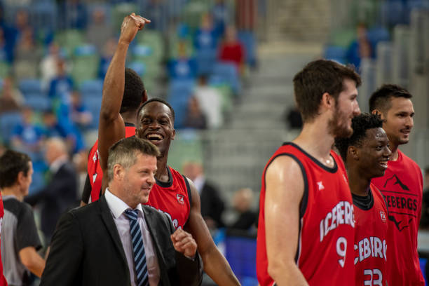 istock Basketball players and coach gather together 1253348378