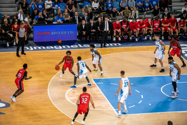 istock Basketball players chasing for ball 1253348381