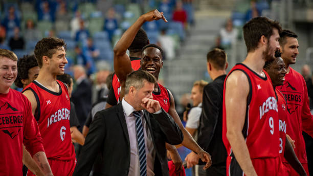 istock Basketball players and coach gather together 1253349188