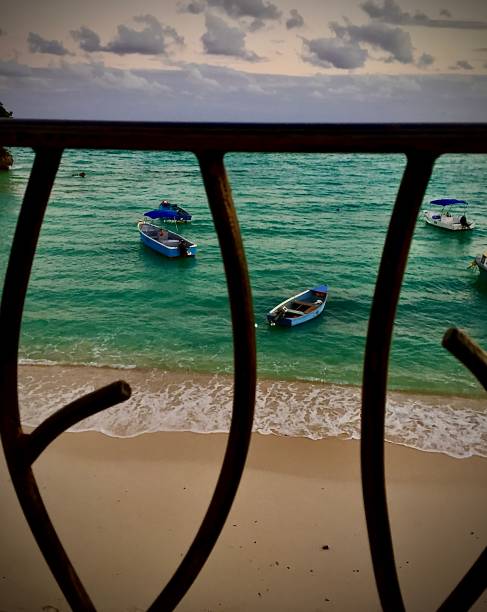 istock Three Tiny Boats in The Caribbean Sea 1253349469