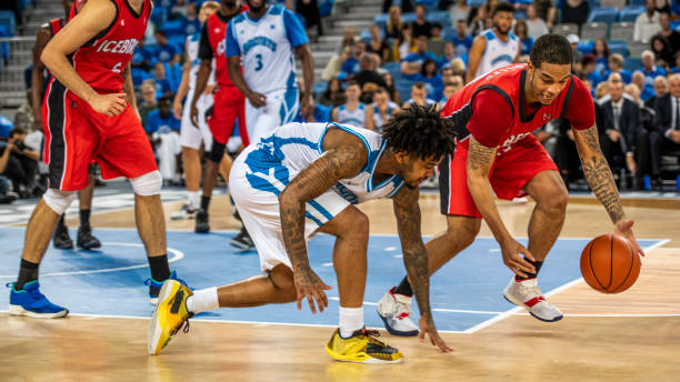 istock Basketball players chasing for ball 1253349503