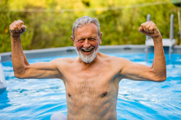 istock Senior man laughing in the pool 1253350303