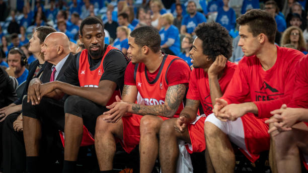 istock Basketball players sitting on bench 1253351150
