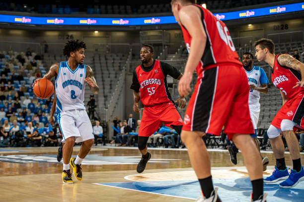 istock Basketball players tackling for ball 1253351155