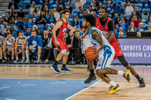 istock Basketball players chasing for ball 1253351463