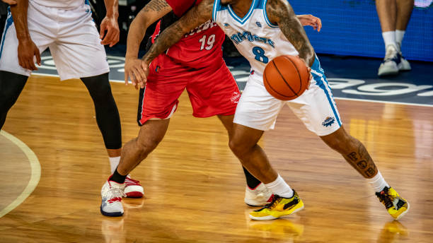 istock Basketball players chasing for ball 1253351465