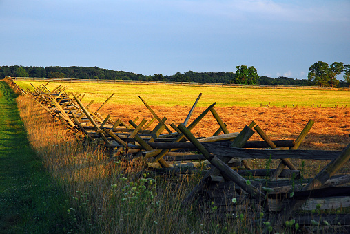 A split rail fence and a walking trail lead off to the horizon in Gettysburg, Pennsylvania