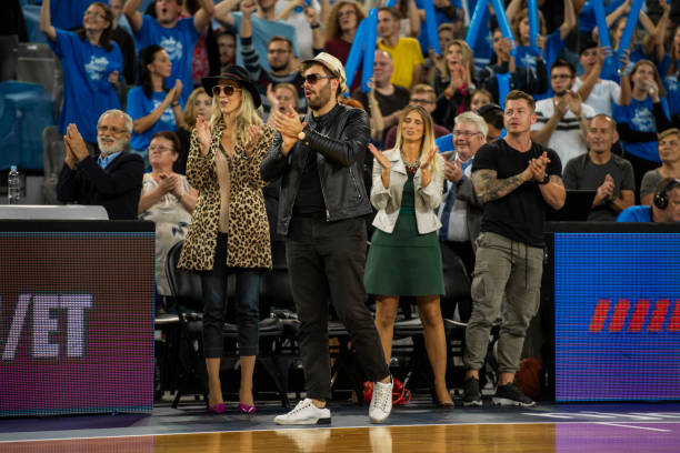 istock Celebrities watching basketball match 1253352249