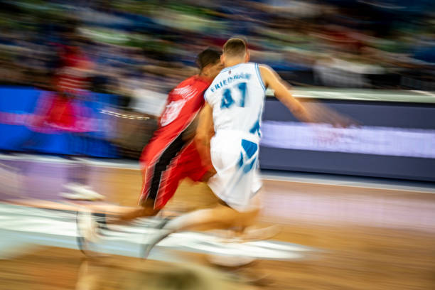 istock Basketball players chasing for ball 1253352426