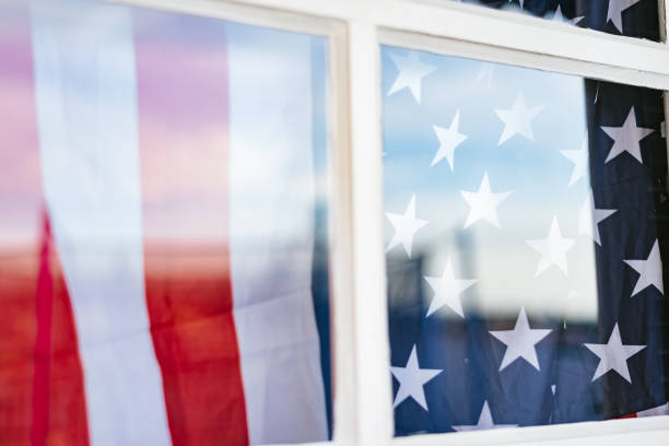 istock Covid-19: USA flag in the window 1253353653