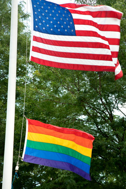 istock American and LGBT flag flying proud on flagpole 1253353782