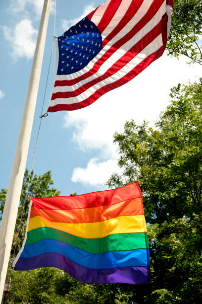 istock LGBT flag and American flag flying high 1253356377