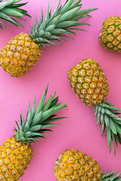 istock Pineapple tropical fruit on pink pastel background 1253365706