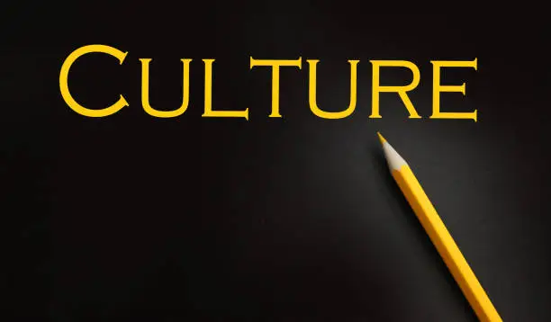Photo of Culture word typed in yellow on black paper , social concept background