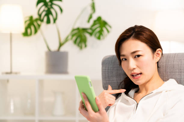 istock asian woman to see a smart phone,think, 1253371408