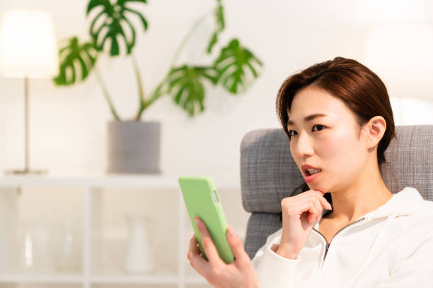 istock asian woman to see a smart phone,think, 1253371489