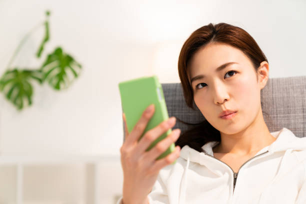 istock asian woman to see a smart phone,think, 1253371505