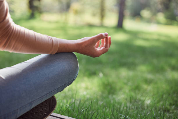 istock Young lady is practicing yoga in park 1253374940