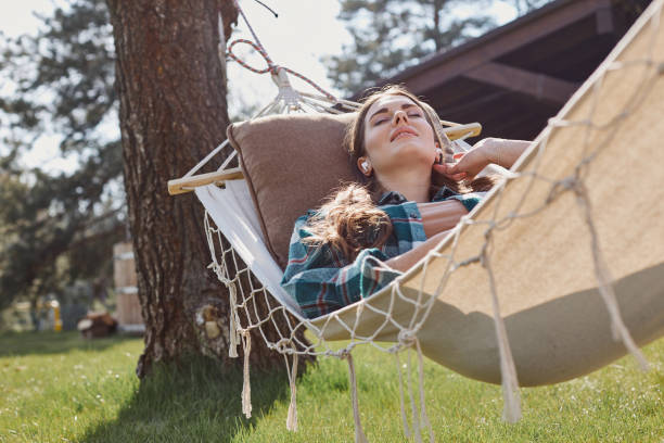 istock Happy lady with eyes closed resting in the garden 1253375596