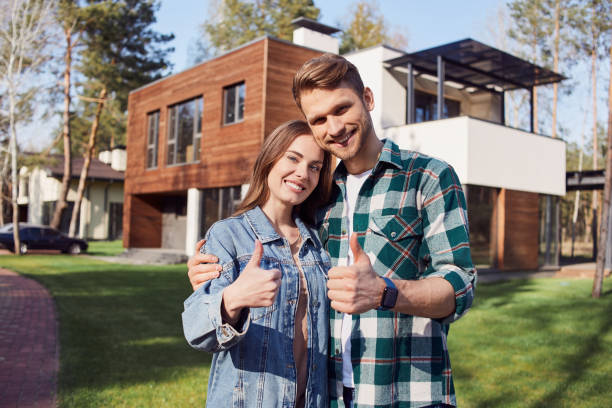 istock Smiling young family hugging and looking at camera 1253375779
