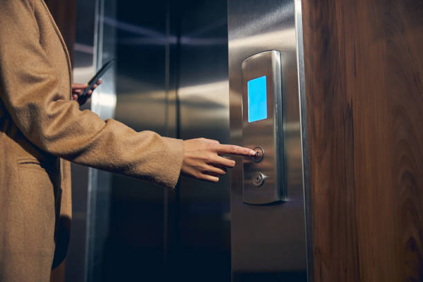 istock Woman wearing autumn clothes in the elevator 1253378508