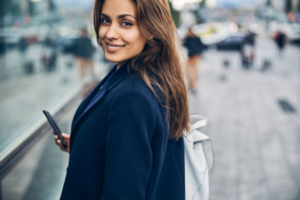 istock Beautiful brunette lady looking happy alone outdoors 1253379500