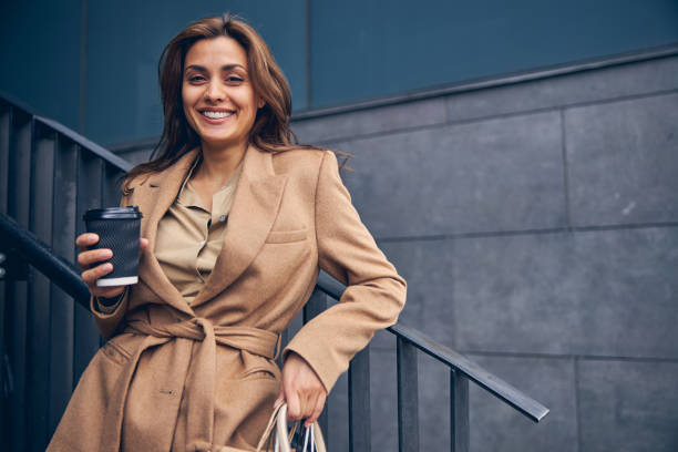 istock Smiling woman leaning back against the rail 1253381473