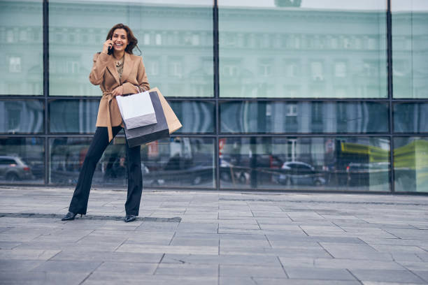 istock Smiling lady chatting on the mobile phone 1253381539