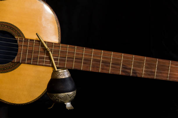istock Mate and guitar, concept of Argentine folklore, isolated on black background 1253383321