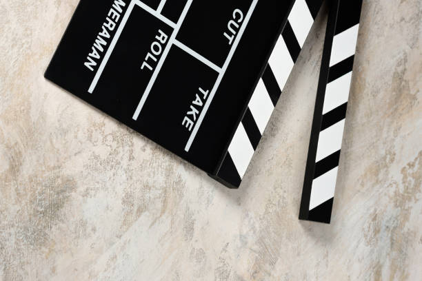 istock Clapper board with popcorn. Movie concept. Clapperboard on a textural background. Close-up. Copy space. 1253385089