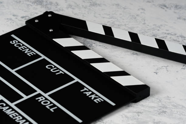 istock Clapper board with popcorn. Movie concept. Clapperboard on a textural background. Close-up. Copy space. 1253385110