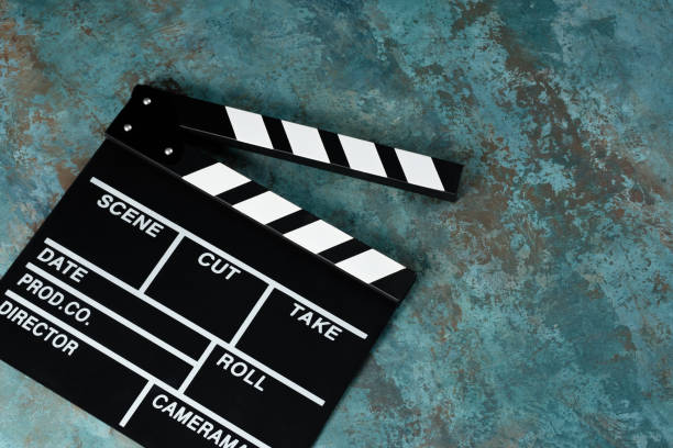 istock Clapper board with popcorn. Movie concept. Clapperboard on a textural background. Close-up. Copy space. 1253385138