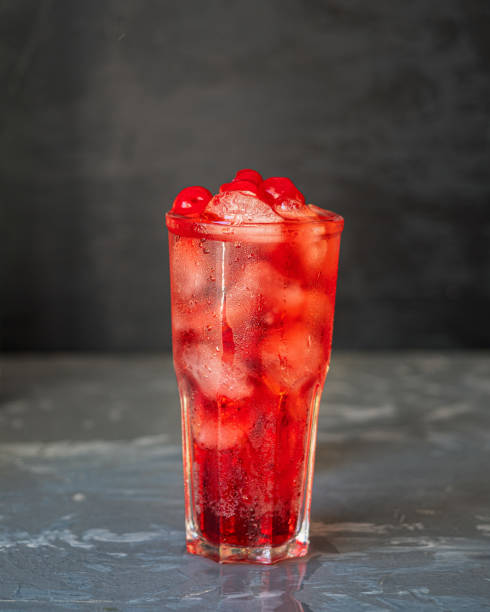 istock Close-up soft drink with cherry and ice in a tall glass 1253388377
