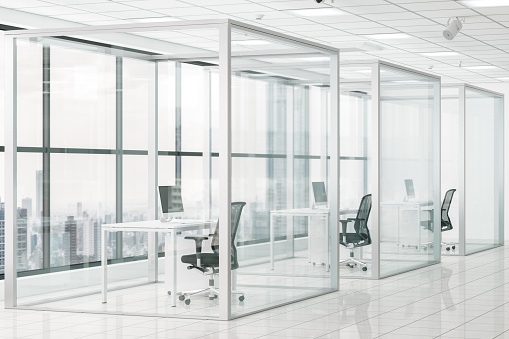 Social Distancing in Modern Office With Glass Cubicle.