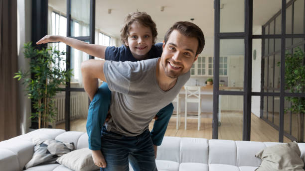 istock Overjoyed father and son playing together at home 1253390154