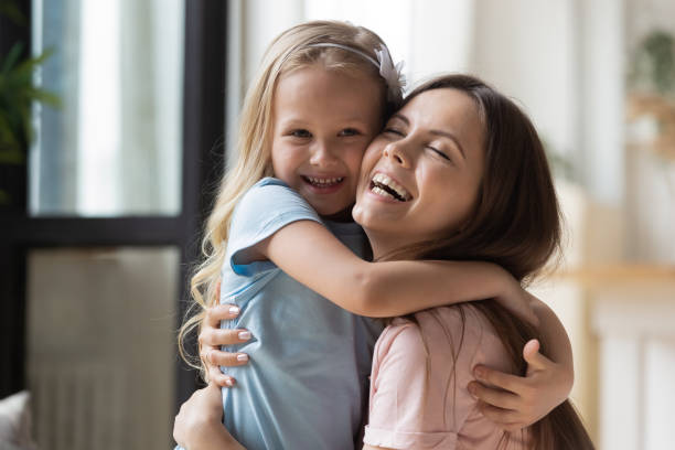 istock Overjoyed mom and little daughter cuddle showing love 1253390161