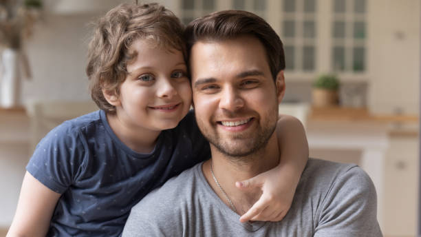 istock Portrait of smiling young dad and son hugging 1253390164