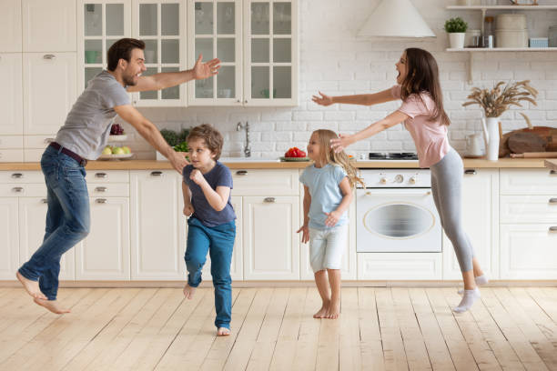 istock Overjoyed parents have fun dancing with small kids 1253390200