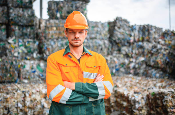 istock Serious Workman Standing Outdoors at Recycling Facility 1253390340