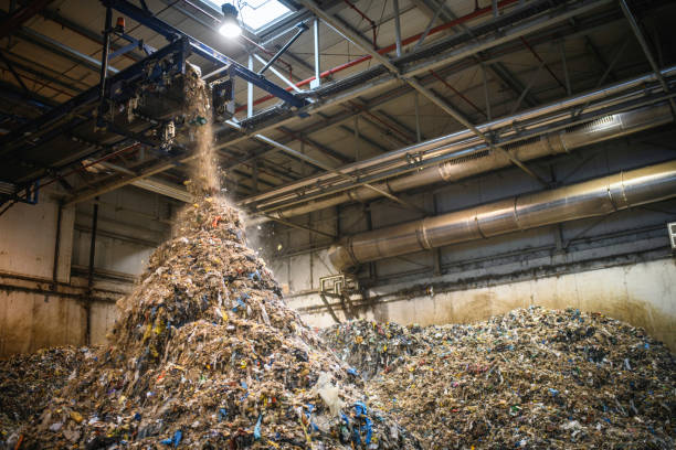 istock Recyclables Falling From Conveyor Belt on Growing Pile 1253390356