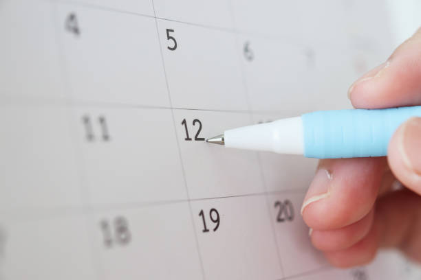 istock Hand with pen writing on calendar date 1253390510
