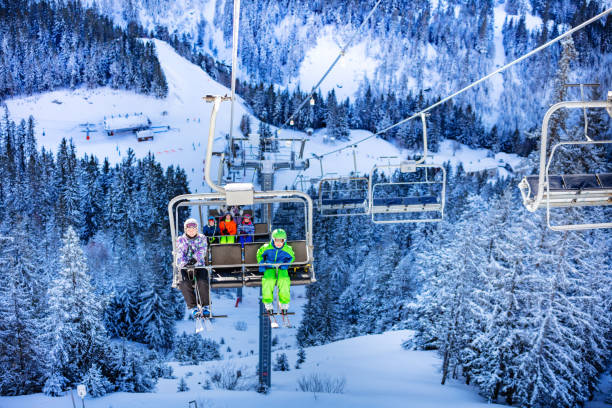 istock Children on the ski lift over magic winter forest 1253390604