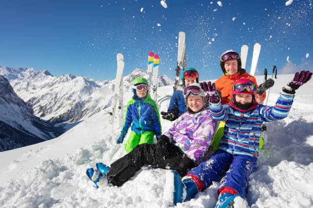 istock Big ski kids group over mountain throw snow up 1253390630